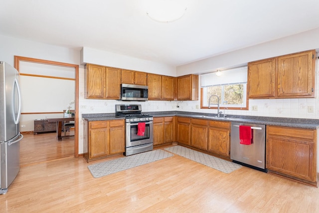 2084 Maplewood Cir, Naperville, IL 60563 - kitchen with a sink, light wood-style flooring, appliances with stainless steel finishes, and brown cabinets
