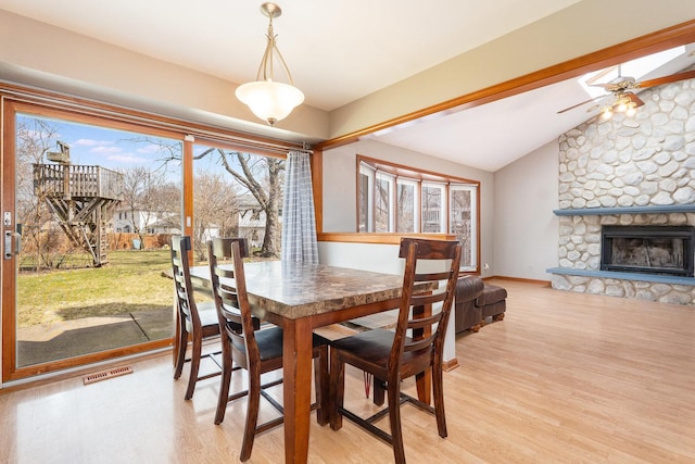 2084 Maplewood Cir, Naperville, IL 60563 - dining space featuring visible vents, light wood-style flooring, vaulted ceiling, and a healthy amount of sunlight