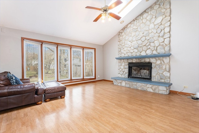 2084 Maplewood Cir, Naperville, IL 60563 - living area with baseboards, a stone fireplace, a ceiling fan, and wood finished floors