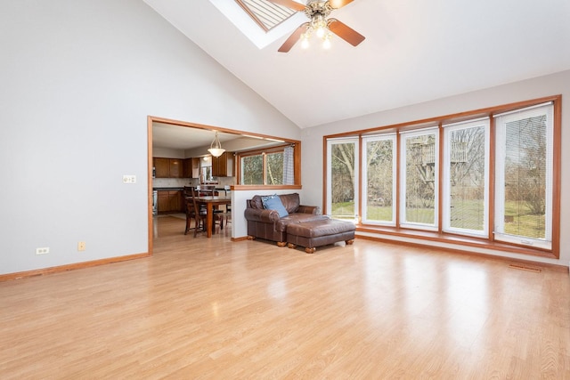 2084 Maplewood Cir, Naperville, IL 60563 - sitting room featuring light wood-type flooring, ceiling fan, high vaulted ceiling, and baseboards