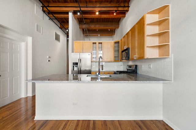 kitchen featuring a sink, a peninsula, wood ceiling, beam ceiling, and stainless steel appliances