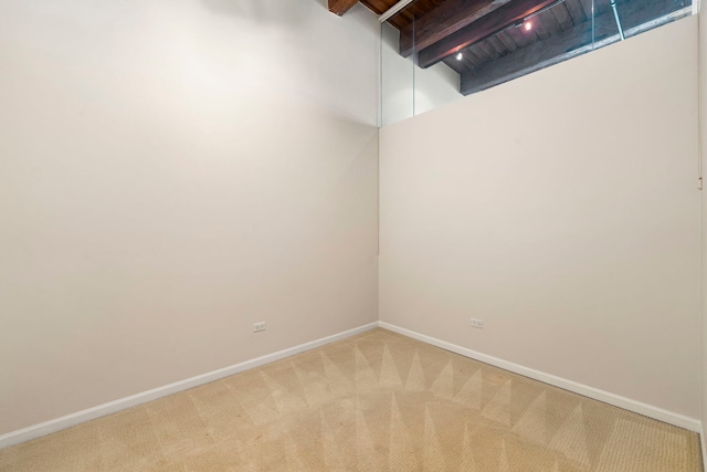 basement with baseboards and light carpet