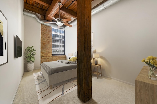 bedroom with baseboards, carpet flooring, beamed ceiling, ceiling fan, and wood ceiling