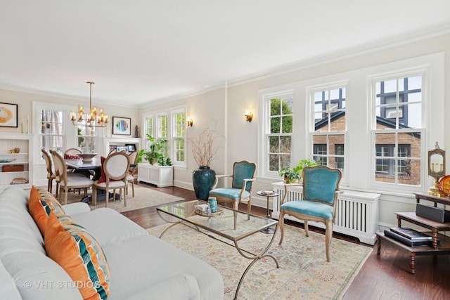 1149 Scott Ave, Winnetka, IL 60093 - living room with crown molding, radiator, hardwood / wood-style floors, baseboards, and a notable chandelier