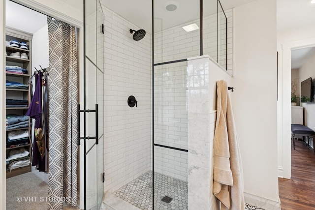 1149 Scott Ave, Winnetka, IL 60093 - bathroom featuring wood finished floors, a spacious closet, and a shower stall