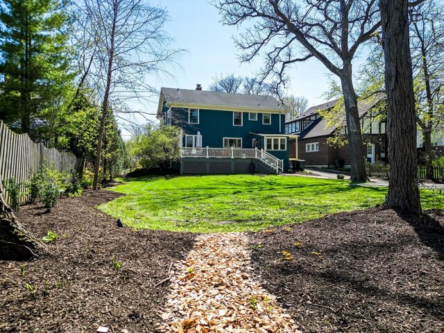 1149 Scott Ave, Winnetka, IL 60093 - rear view of house featuring stairs, a deck, a fenced backyard, a chimney, and a yard