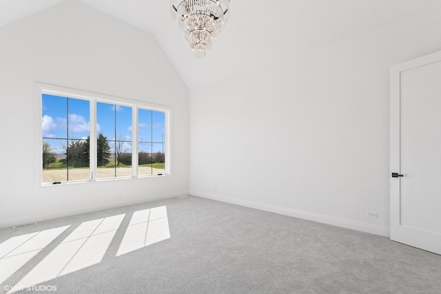unfurnished room with high vaulted ceiling, carpet, and an inviting chandelier