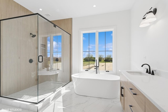 bathroom featuring a shower stall, a freestanding tub, vanity, and marble finish floor
