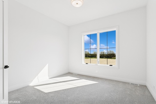 unfurnished room featuring carpet flooring, baseboards, and visible vents