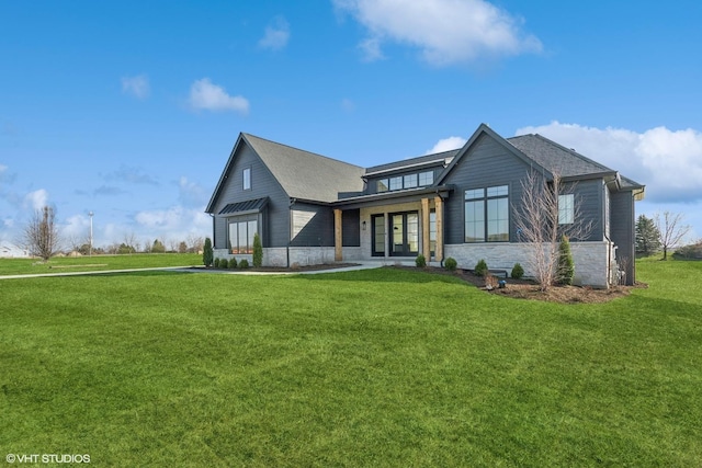 exterior space with stone siding and a front lawn