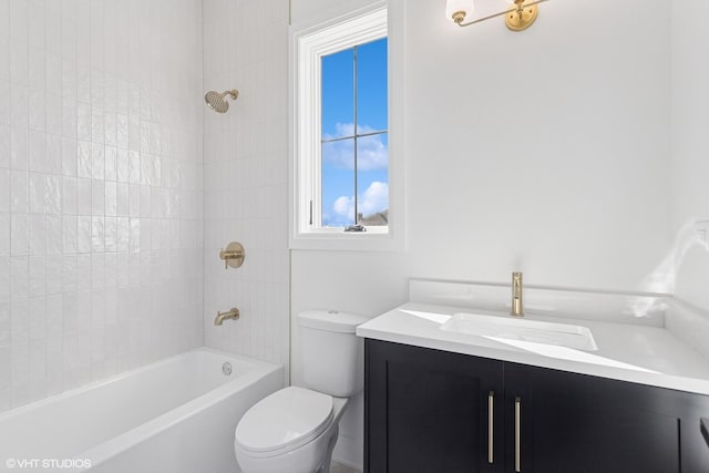bathroom featuring bathing tub / shower combination, vanity, and toilet