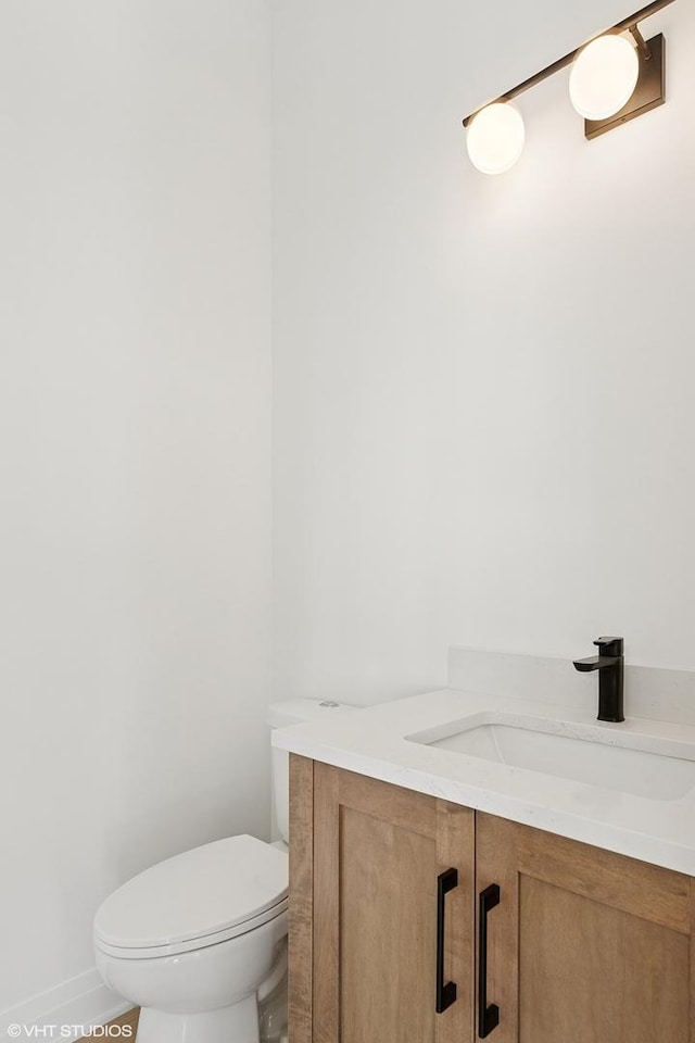bathroom featuring vanity and toilet