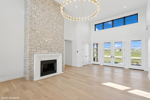 unfurnished living room with a towering ceiling and a wealth of natural light
