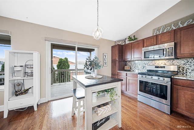 6834 Oak View Ct, Oak Forest, IL 60452 - kitchen with appliances with stainless steel finishes, backsplash, light wood finished floors, pendant lighting, and vaulted ceiling