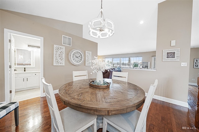 6834 Oak View Ct, Oak Forest, IL 60452 - dining space featuring a chandelier, wood finished floors, lofted ceiling, and baseboards