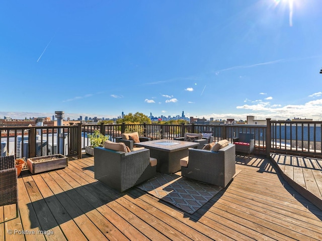 deck with an outdoor living space with a fire pit