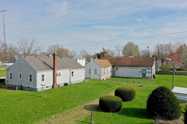 view of yard with central AC and fence