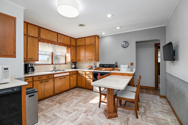 kitchen featuring a sink, visible vents, white microwave, black dishwasher, and electric range oven