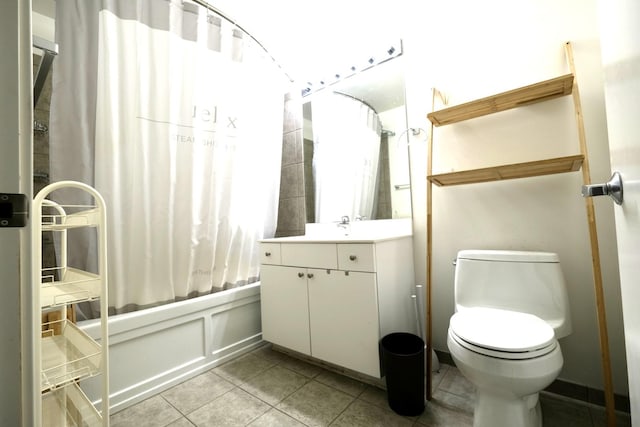 full bath with shower / bath combo, tile patterned floors, vanity, and toilet