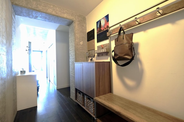mudroom featuring dark wood-style flooring and baseboards