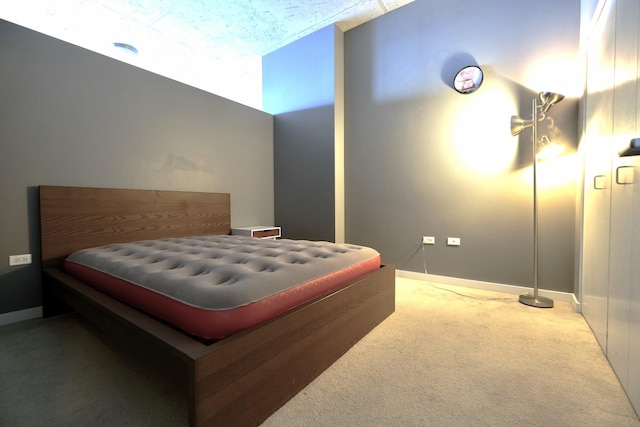 bedroom with baseboards and carpet