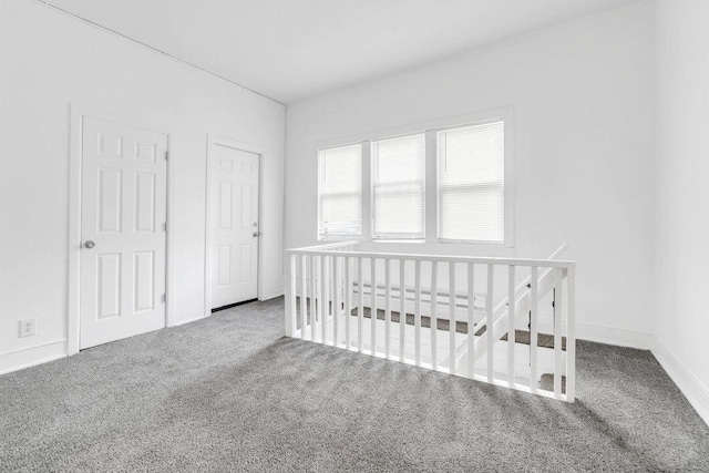 carpeted bedroom with baseboards and a nursery area