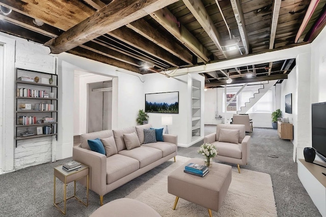 carpeted living area with stairs