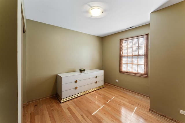 unfurnished bedroom with visible vents, baseboards, and light wood-style flooring