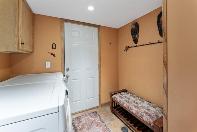 laundry area with washing machine and clothes dryer, cabinet space, and recessed lighting