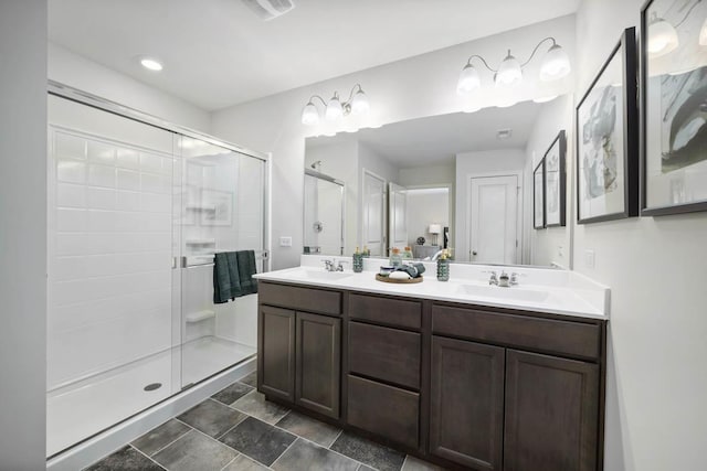 bathroom featuring a sink, visible vents, double vanity, and a stall shower