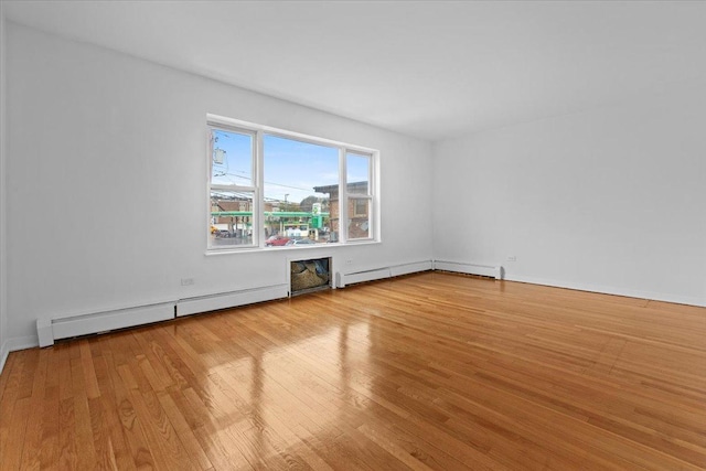 415 S Maple St Unit 402, Oak Park, IL 60302 - empty room featuring baseboards, wood finished floors, and a baseboard radiator