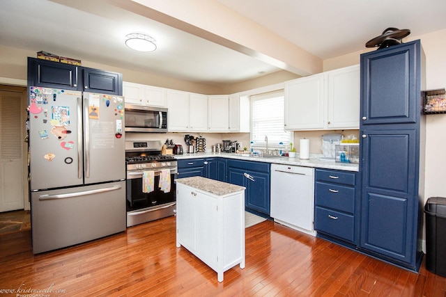 536 Evergreen Ln, Bradley, IL 60915 - kitchen featuring a sink, light countertops, appliances with stainless steel finishes, white cabinetry, and blue cabinets
