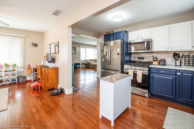 536 Evergreen Ln, Bradley, IL 60915 - kitchen featuring stainless steel appliances, visible vents, blue cabinets, and wood finished floors