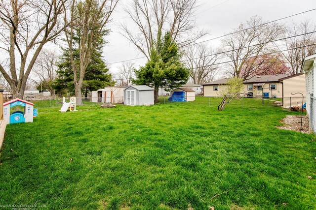 536 Evergreen Ln, Bradley, IL 60915 - view of yard featuring a shed, an outdoor structure, and fence