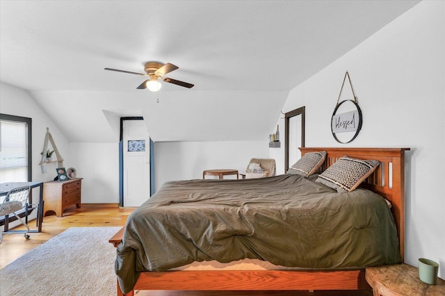 bedroom featuring vaulted ceiling, ceiling fan, and wood finished floors