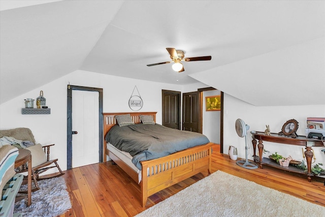 bedroom featuring lofted ceiling, ceiling fan, and wood finished floors
