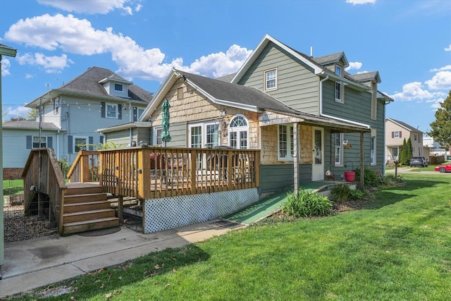 rear view of house featuring a wooden deck, a residential view, and a lawn