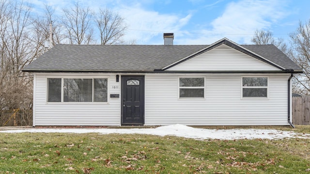 bungalow-style home with a front yard, a shingled roof, fence, and a chimney