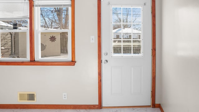 entryway featuring visible vents, baseboards, and marble finish floor