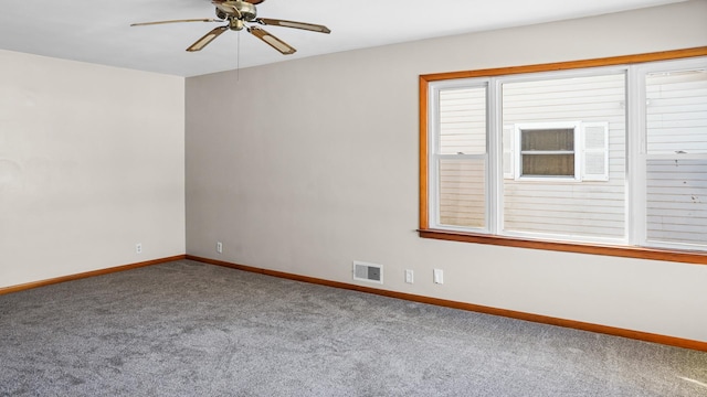 empty room featuring visible vents, ceiling fan, carpet flooring, and baseboards