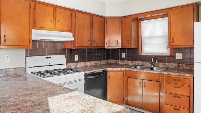 kitchen with under cabinet range hood, decorative backsplash, a sink, and white appliances