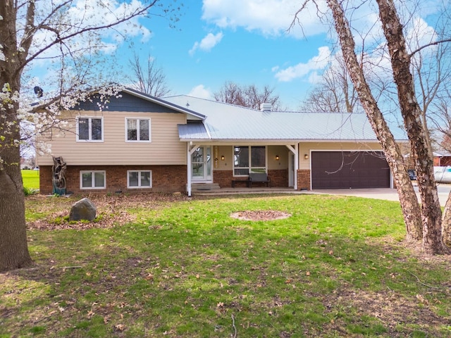10690 E 1700 N Rd, Pontiac, IL 61764 - tri-level home featuring a garage, driveway, a front lawn, and brick siding