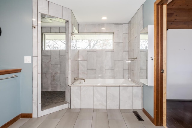 10690 E 1700 N Rd, Pontiac, IL 61764 - bathroom featuring tiled tub, visible vents, baseboards, and a tile shower