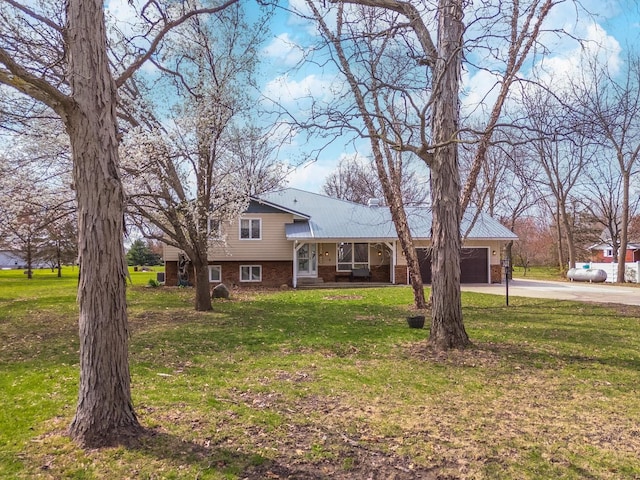 10690 E 1700 N Rd, Pontiac, IL 61764 - split level home featuring brick siding, a front lawn, an attached garage, and concrete driveway