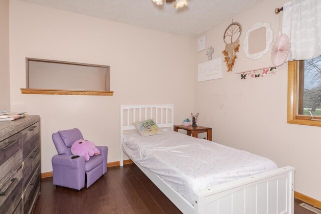 10690 E 1700 N Rd, Pontiac, IL 61764 - bedroom featuring dark wood-style flooring, baseboards, and visible vents