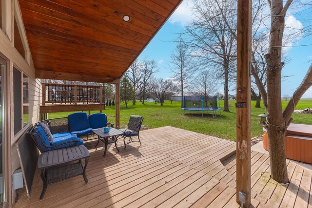 10690 E 1700 N Rd, Pontiac, IL 61764 - wooden terrace featuring a trampoline, an outdoor hangout area, and a lawn