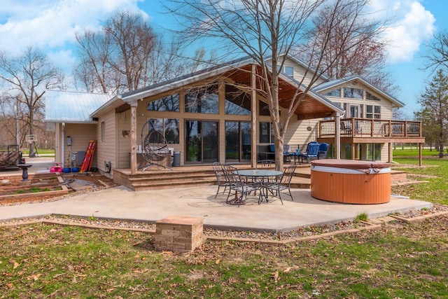 10690 E 1700 N Rd, Pontiac, IL 61764 - back of property featuring a patio, a deck, a hot tub, and metal roof