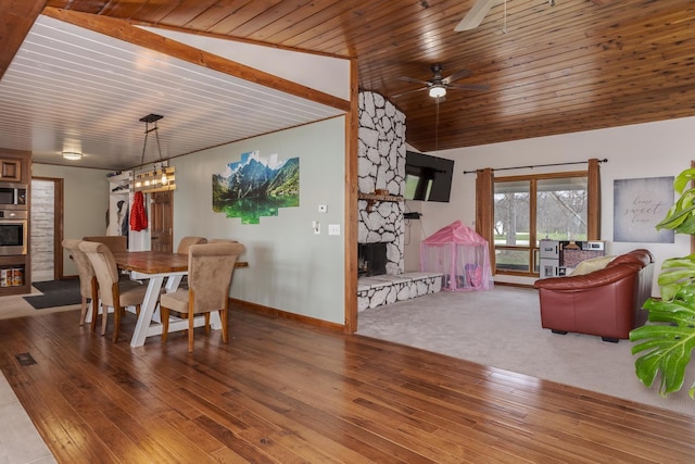 10690 E 1700 N Rd, Pontiac, IL 61764 - dining space featuring baseboards, a stone fireplace, ceiling fan, wood ceiling, and wood-type flooring