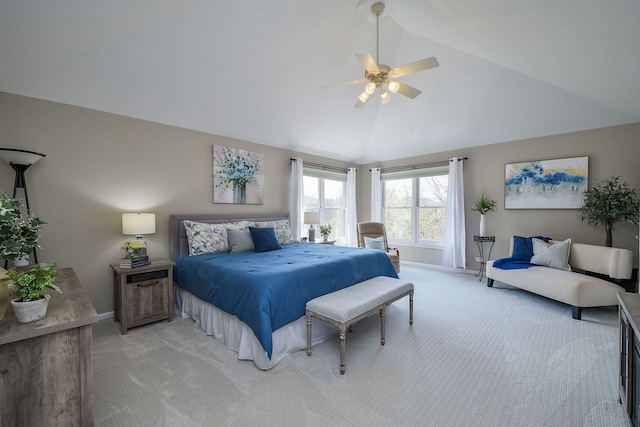 bedroom with baseboards, vaulted ceiling, and light carpet