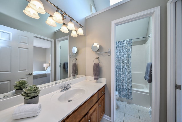 ensuite bathroom with vanity, tile patterned flooring, shower / bath combo with shower curtain, toilet, and ensuite bath
